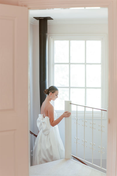 A Bride is seldom alone in choosing her gown...