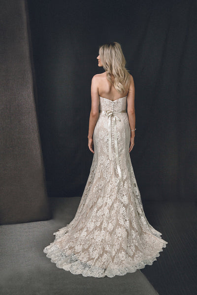 Wedding dress with French lace, sweetheart neckline and scallop edge train.