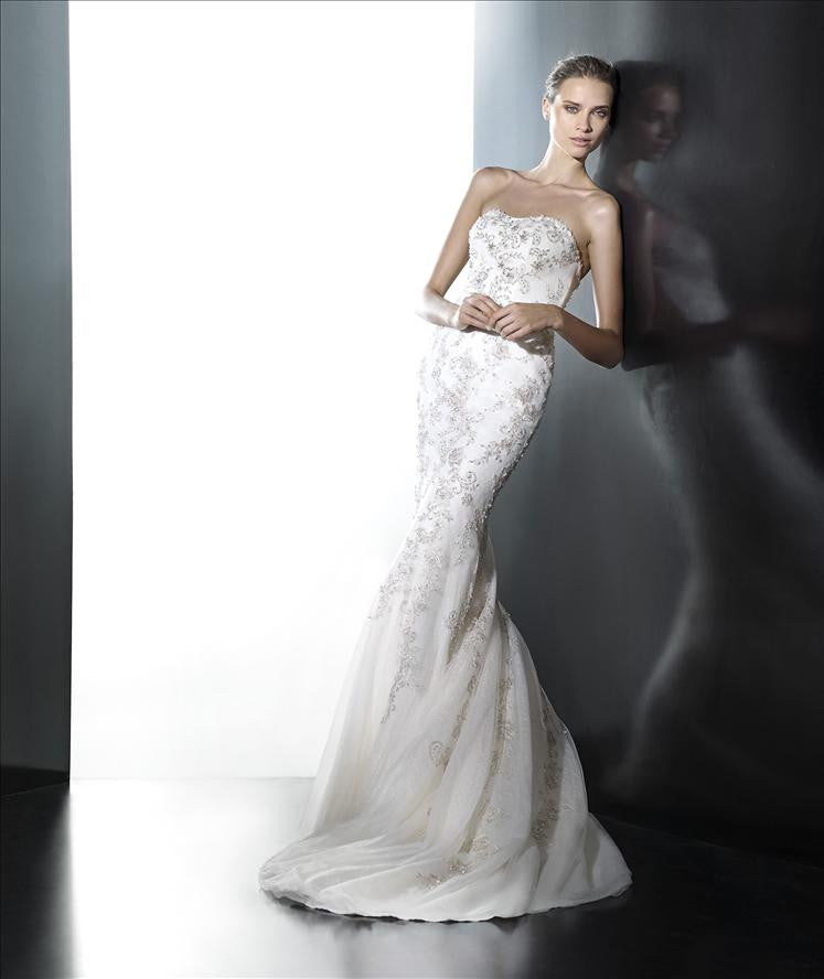 A strapless mermaid wedding dress with embroidery on the bodice leading into the train.