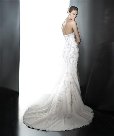 A strapless mermaid wedding dress with embroidery on the bodice leading into the train.